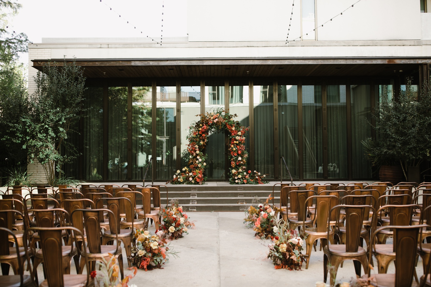 Archway covered in autumn roses for an outdoor ceremony at South Congress Hotel