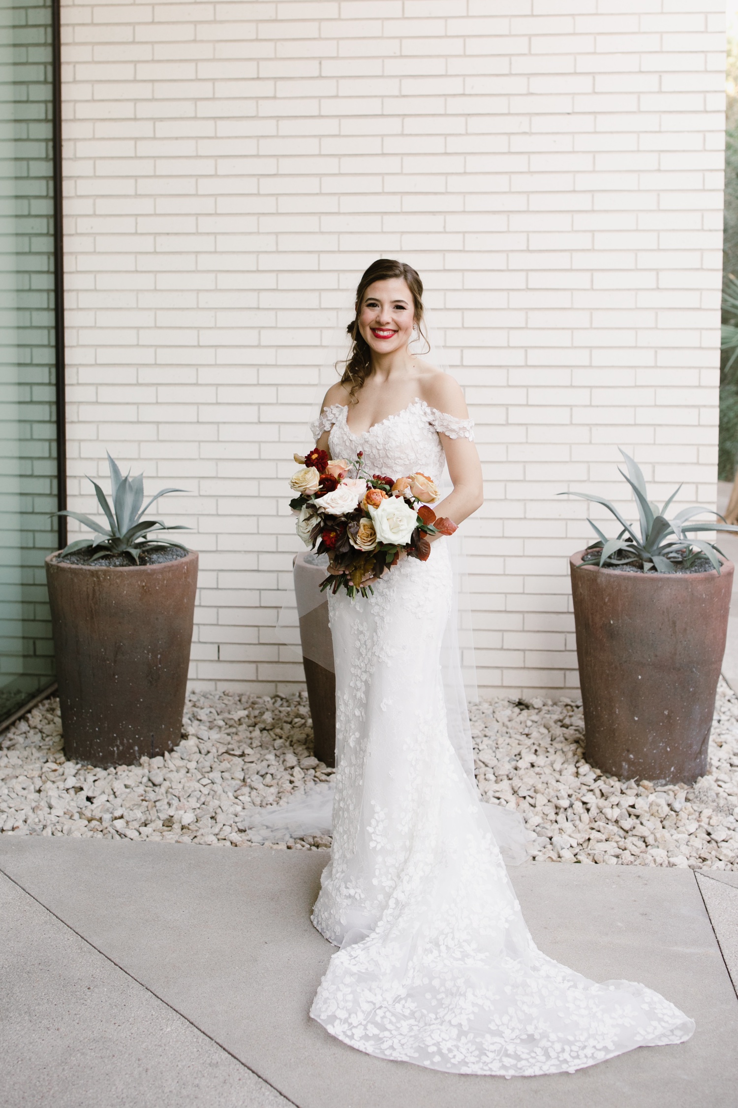 Bride in an off-the-shoulder wedding gown by Lazaro