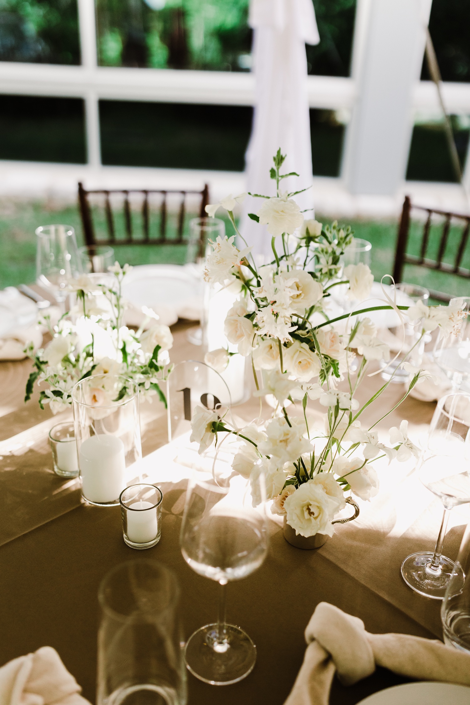 Natural white and ivory floral centerpiece with roses and Peruvian lilies by LOAM STUDIO