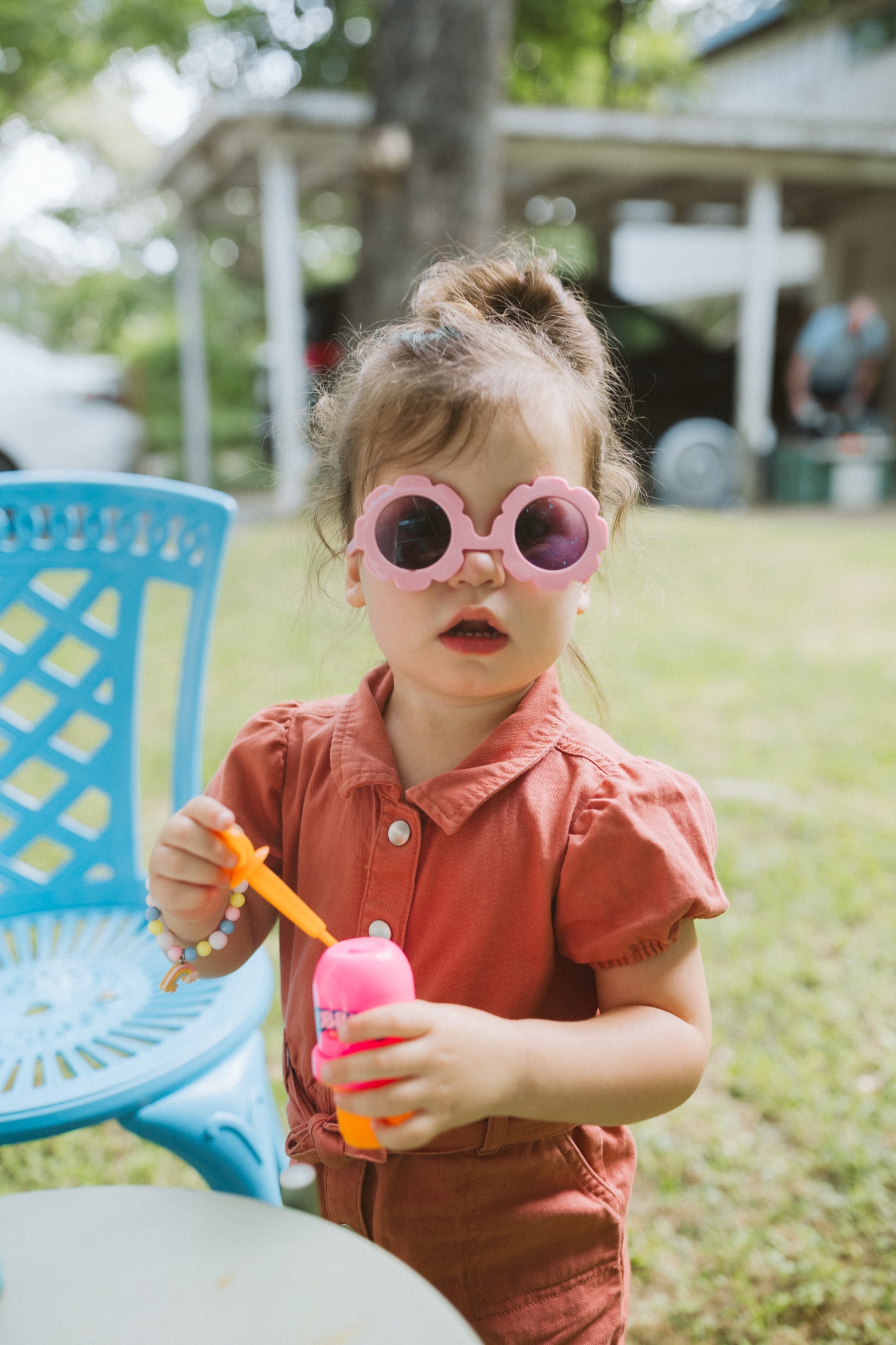 Toddler wearing flower-shaped sunglasses