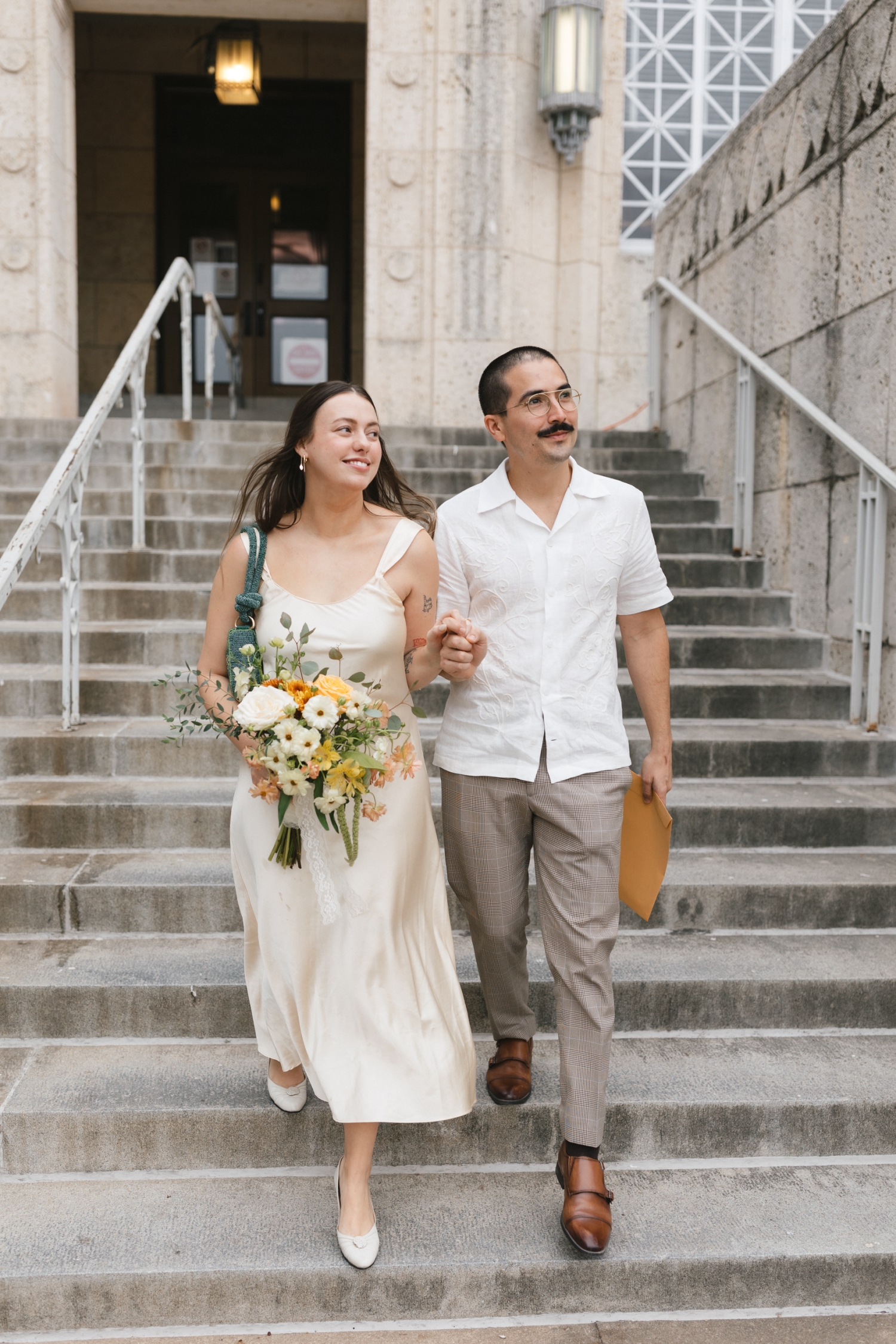 Bride in simple thrifted dressed for courthouse elopement