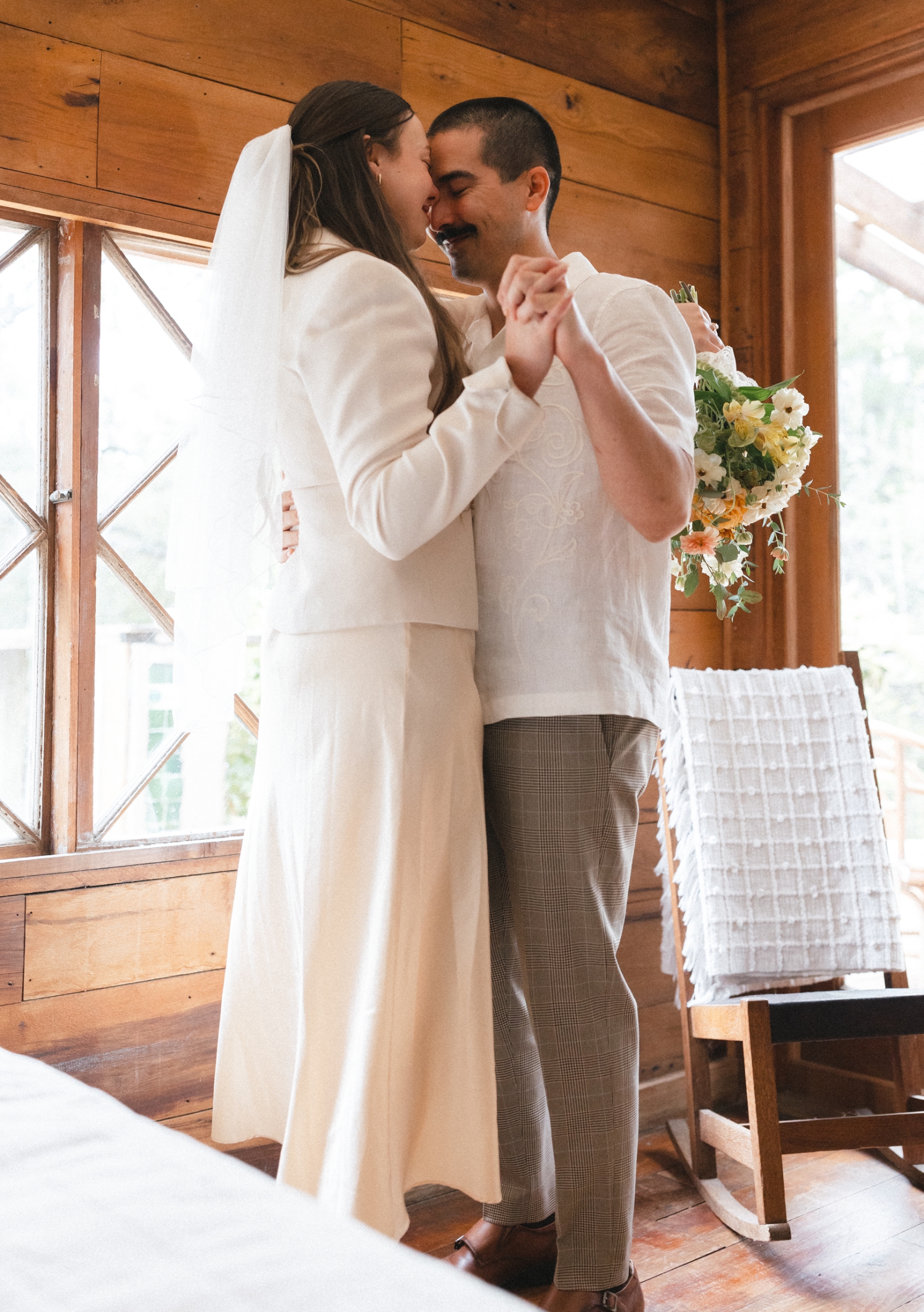 bride and groom getting ready in an Airbnb for their elopement