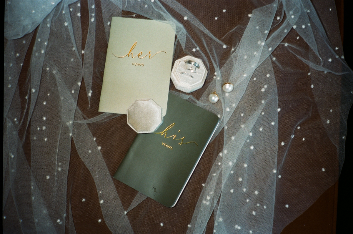 Details of the bride and grooms handwritten vows and jewelry