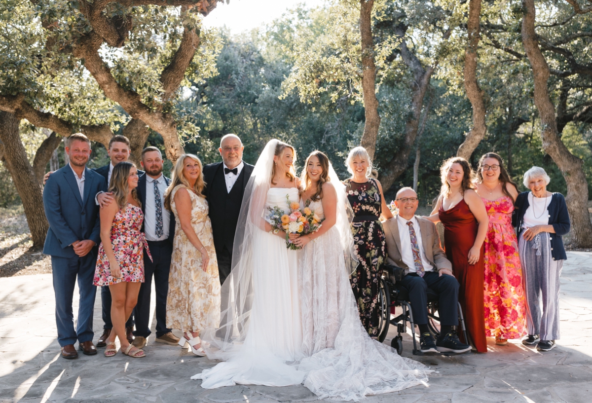 A portrait of a wedding couple with their families at The Addison Grove