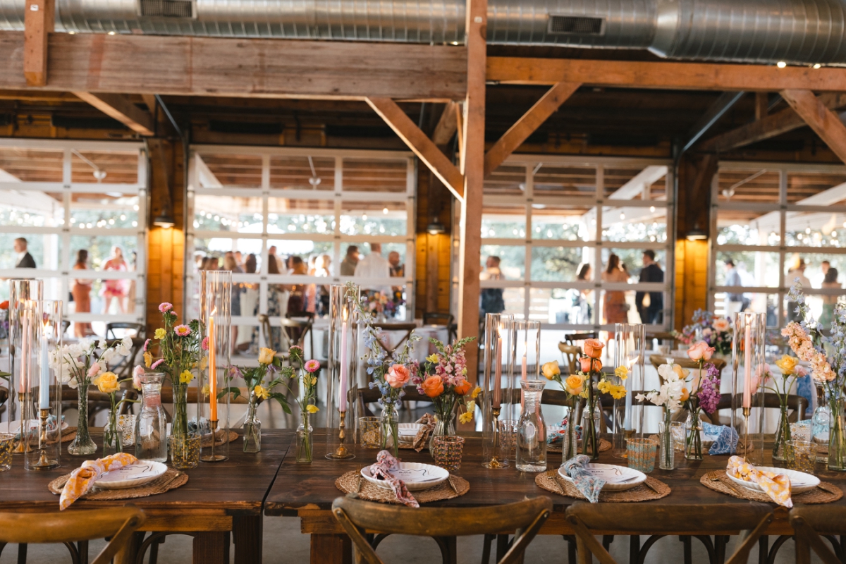 Candles and bright flowers decorating a table for a wedding reception at the Addison Grove