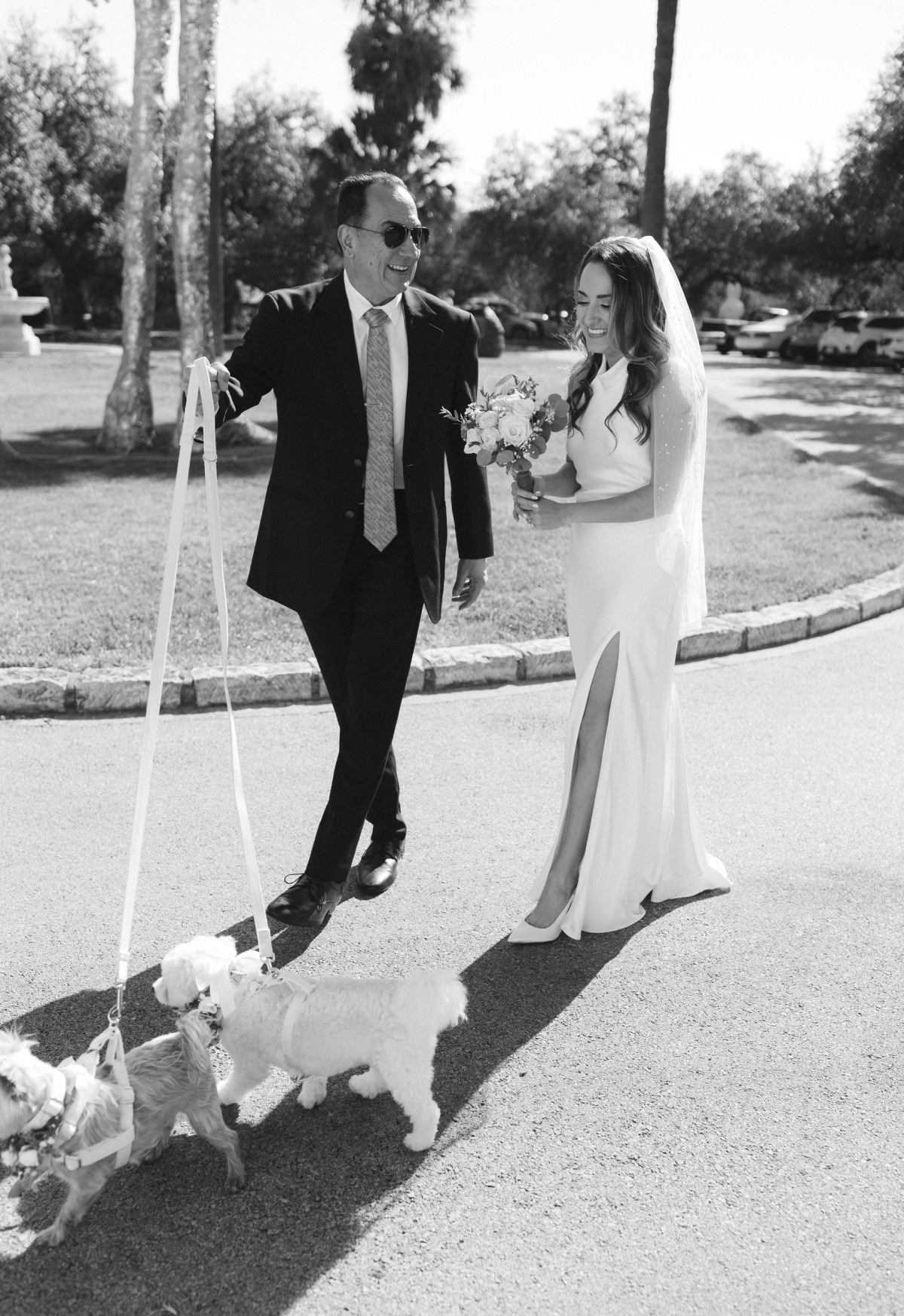 The bride and her father walking the dogs before a wedding ceremony at Laguna Gloria