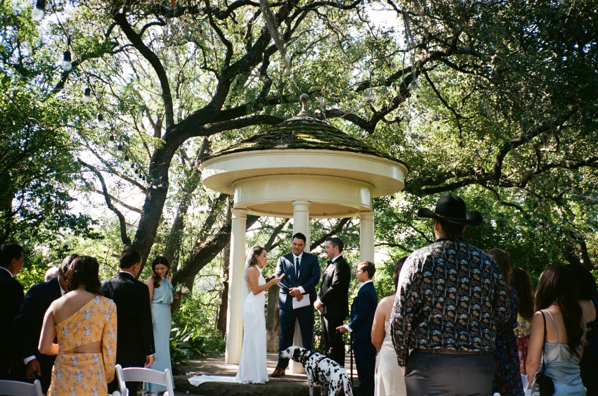 A wedding ceremony beneath a gazebo at Laguna Gloria 