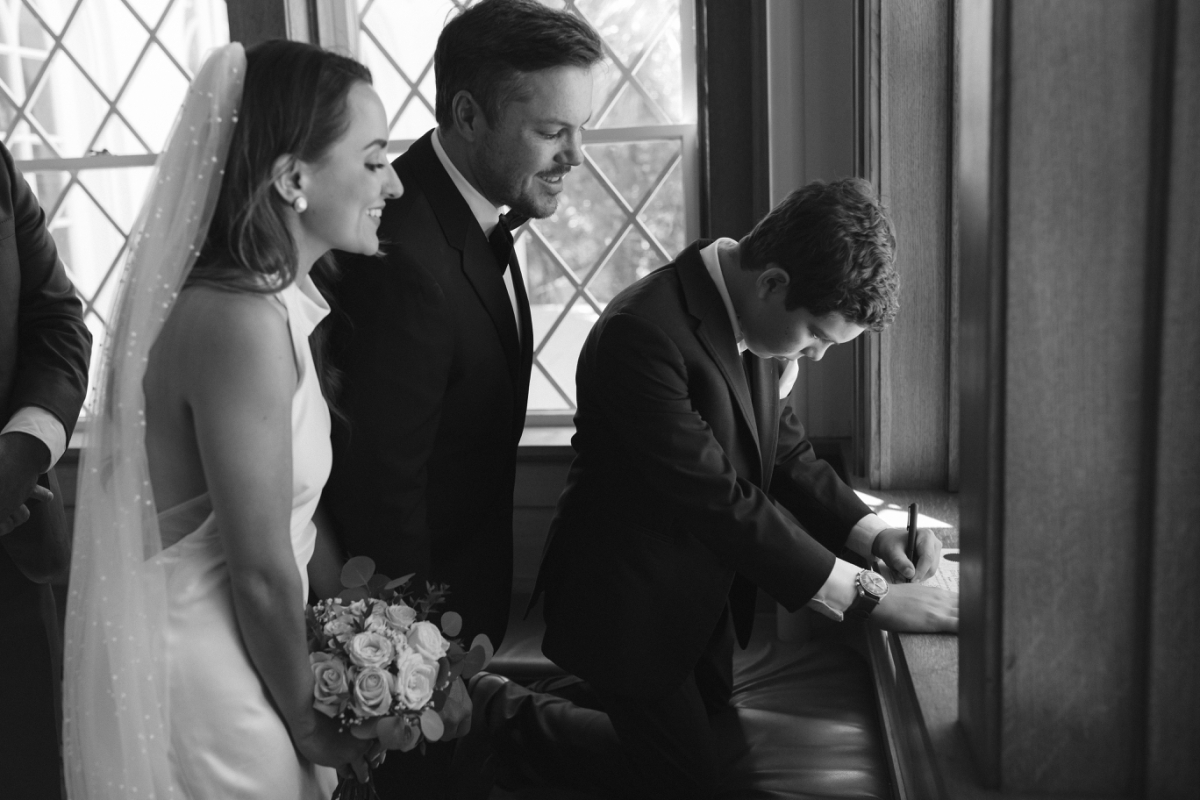 Witnesses signing the marriage certificate at this Laguna Gloria wedding