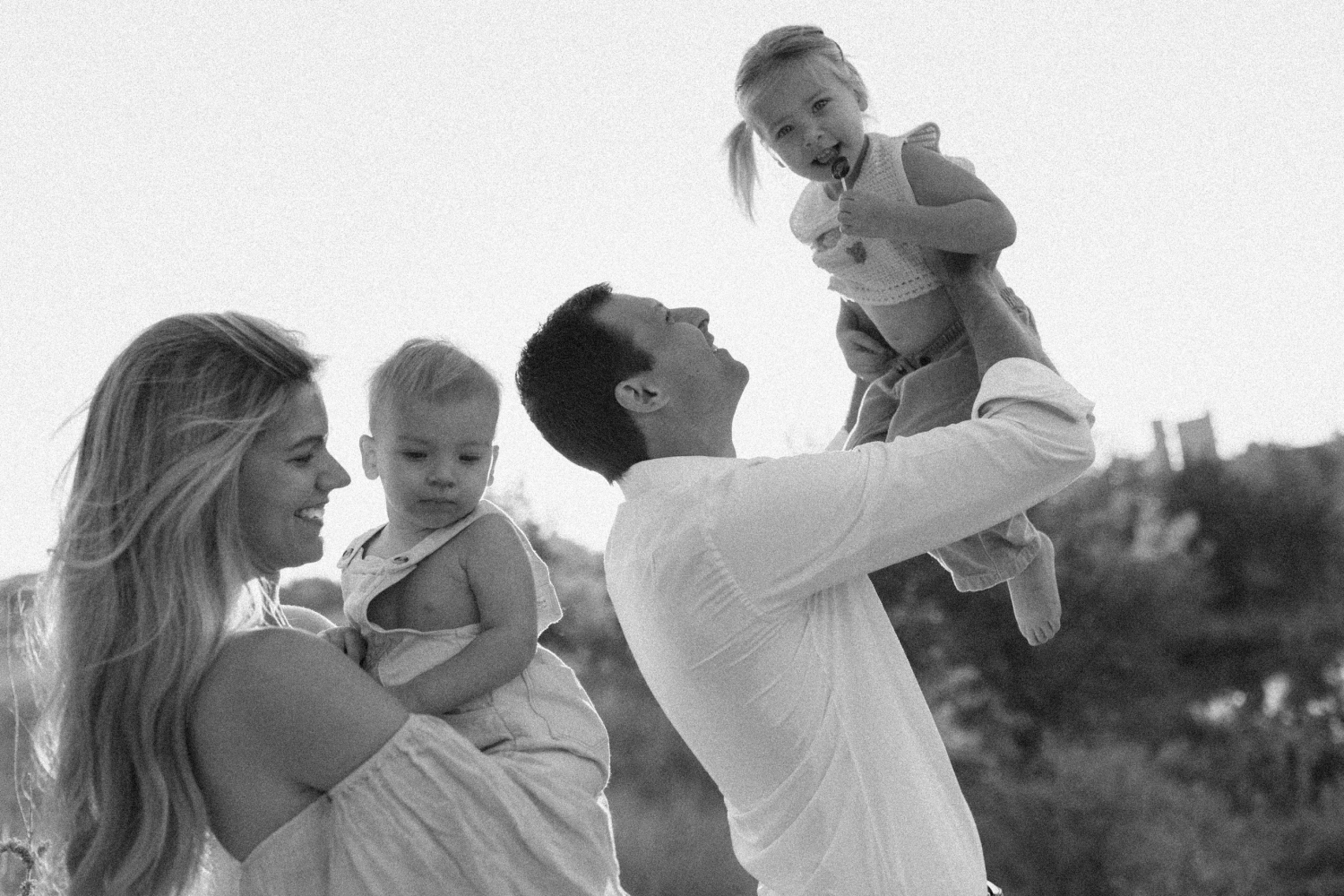 A black and white candid portrait of a family at the Southwest Greenway in Austin, Texas