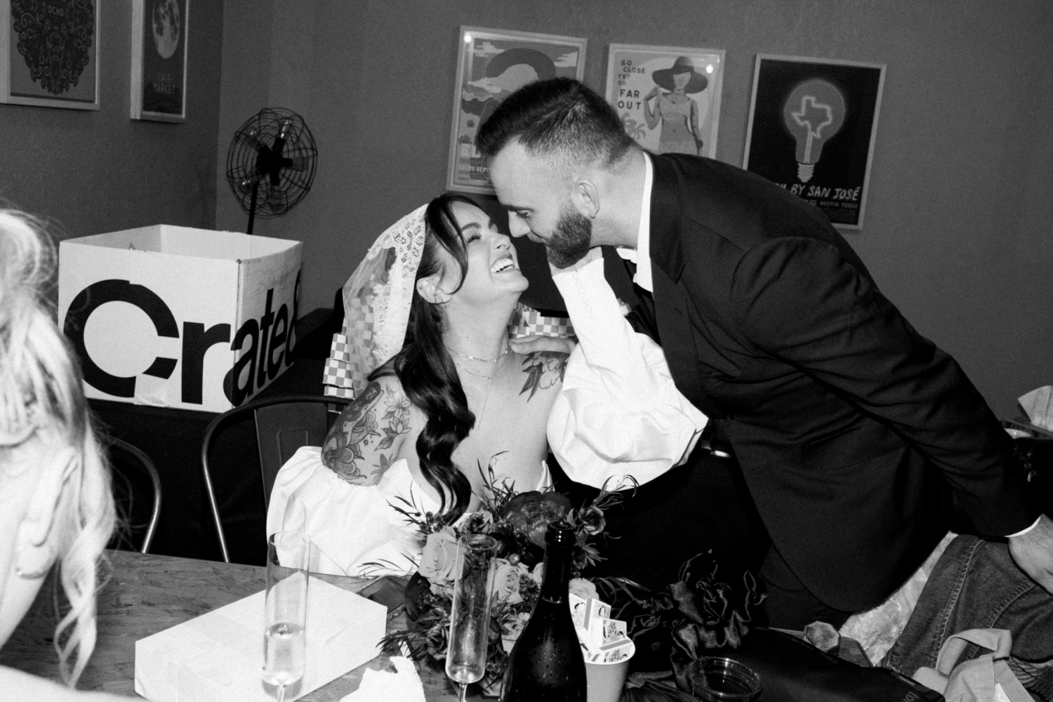 A bride and groom smiling at each other during their wedding reception at Fair Market