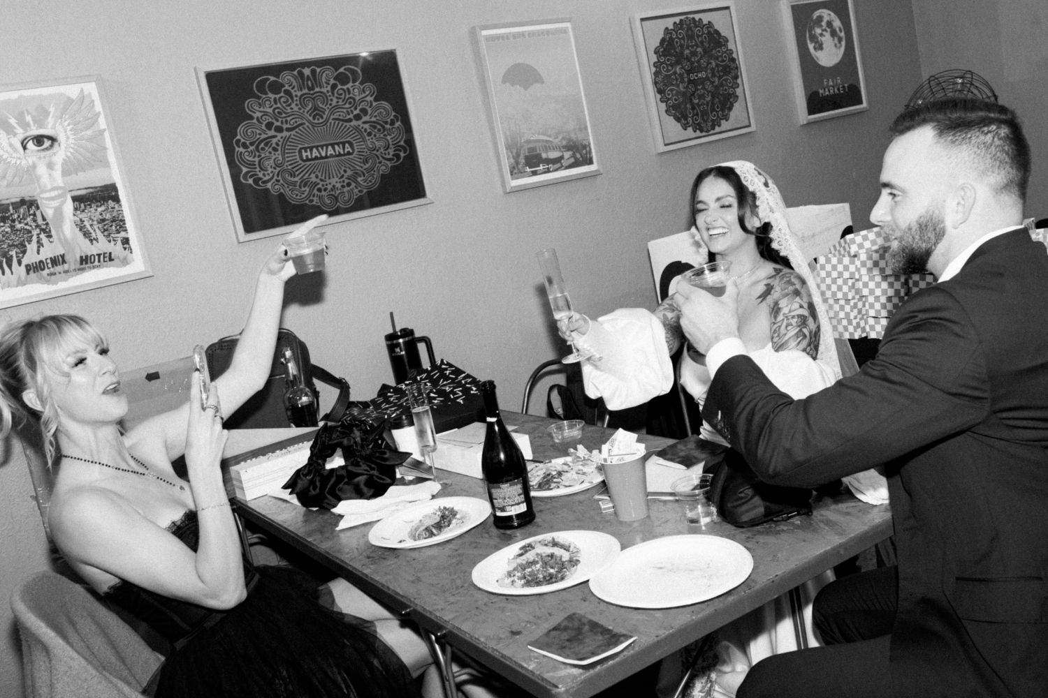 A bride and groom enjoying pizza with their guests 