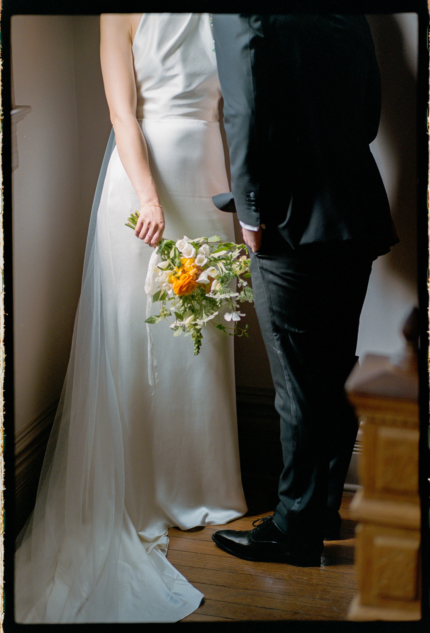 Film portrait of a bride and groom from the waist down