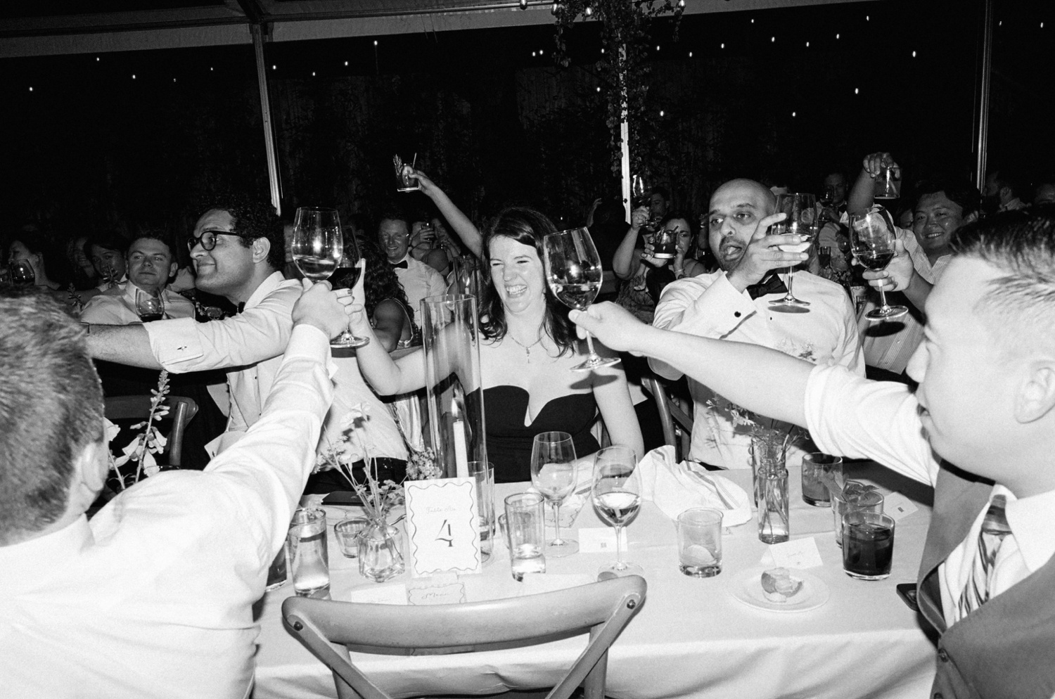 Guests raising their glasses in a toast at an Austin wedding reception