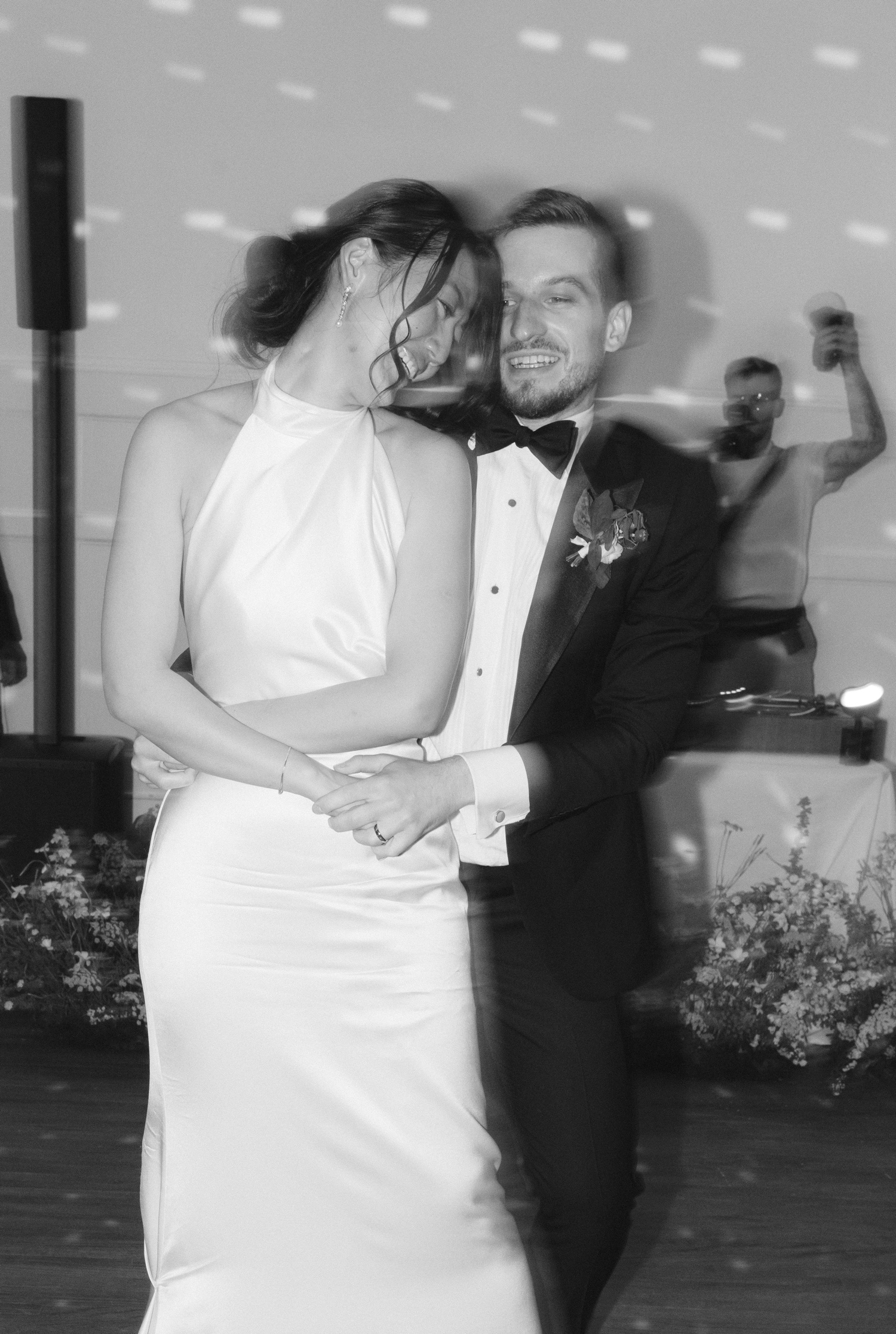 Black and white film of a bride and groom dancing