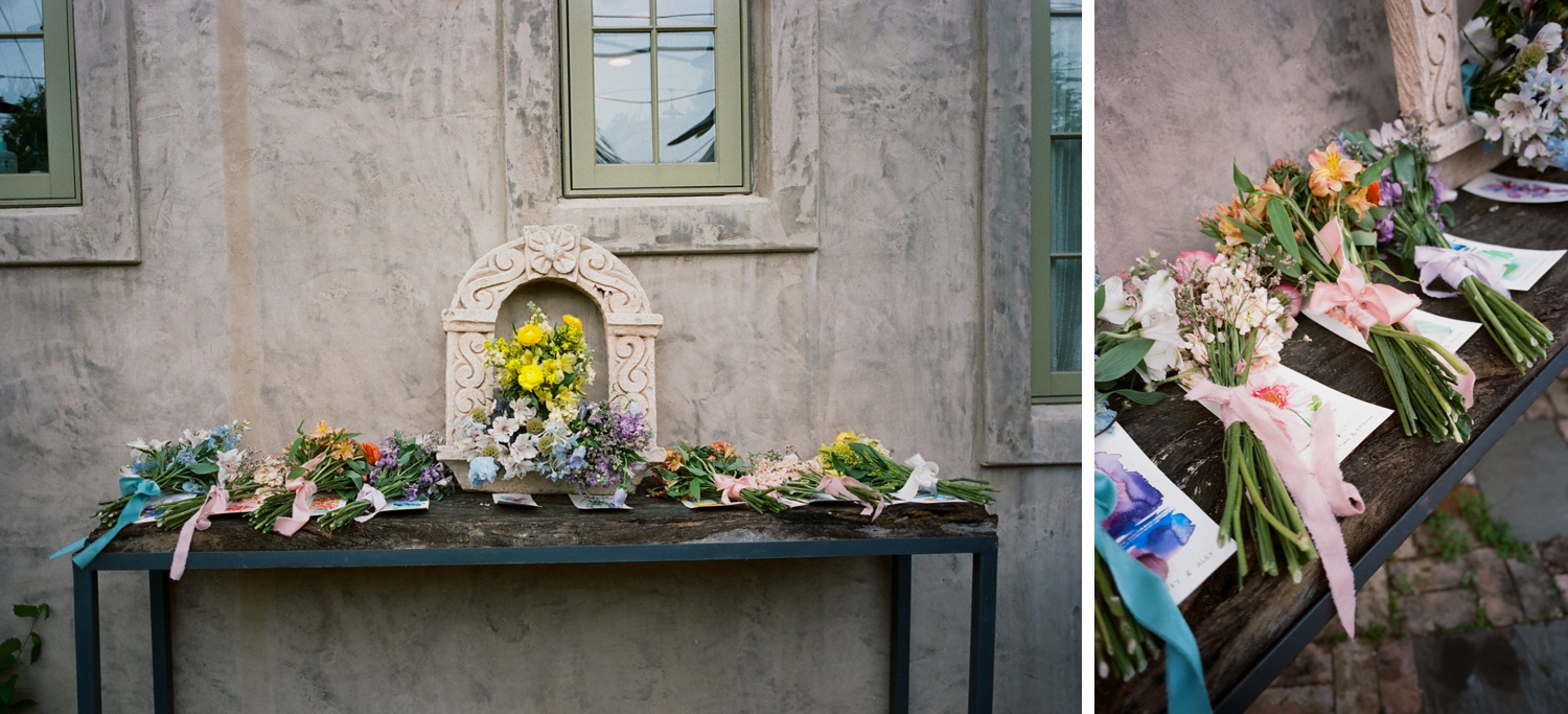 A table covered with colorful monochrome floral bouquets at an Austin wedding