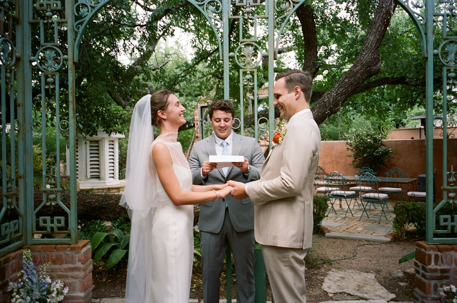 Film of a bride and groom laughing during their wedding ceremony