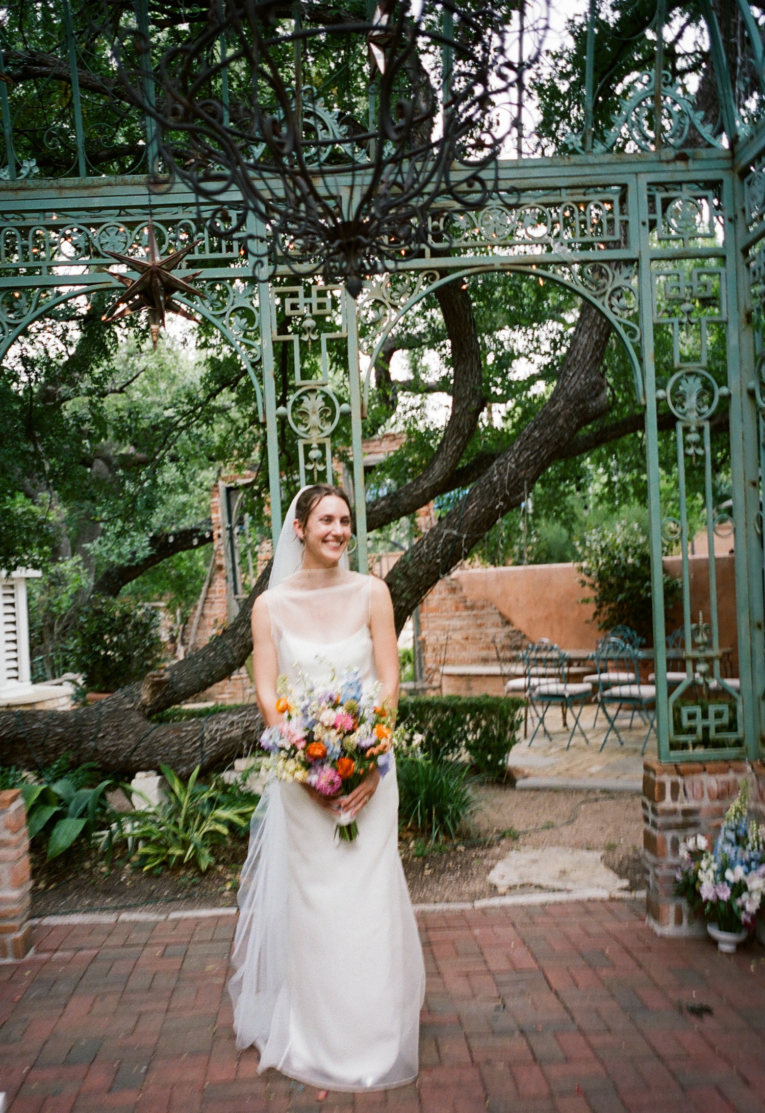 Film of a bride standing in the iron gazebo at The Inn at Jennifer's Gardens