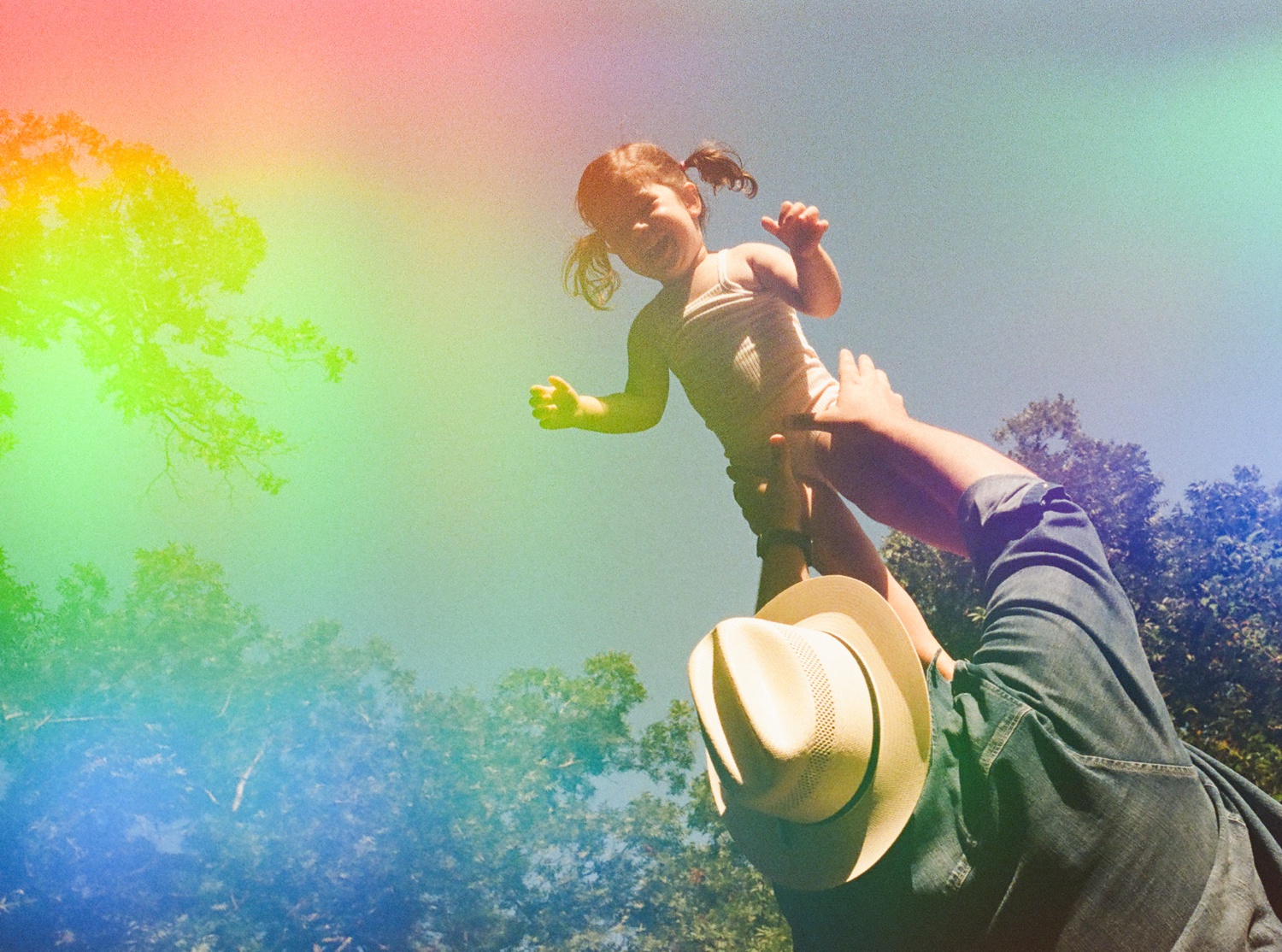 Father tossing his daughter into the air