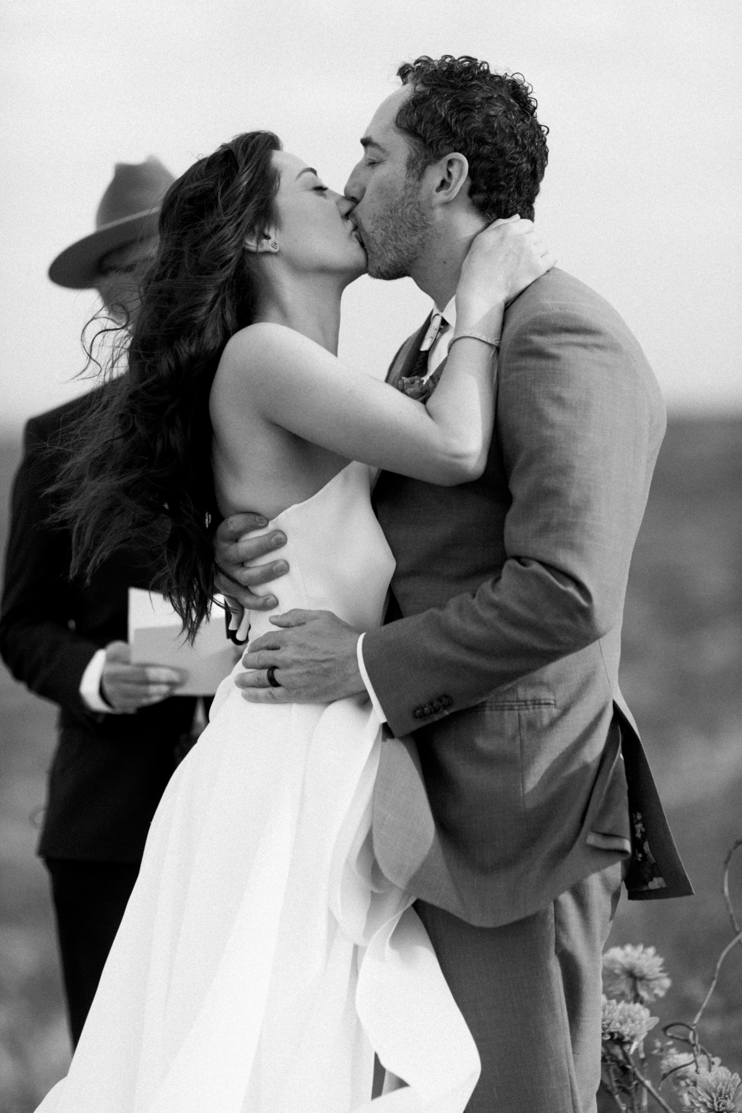 Bride and groom kissing at the end of their wedding ceremony