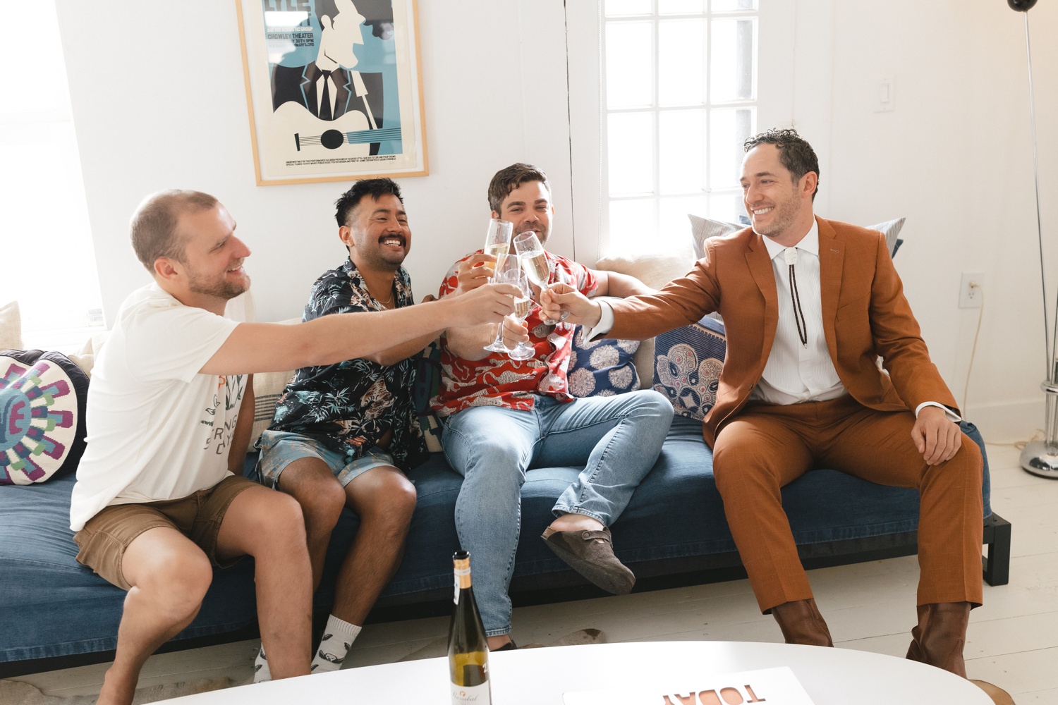 Groom doing a champagne toast with his friends