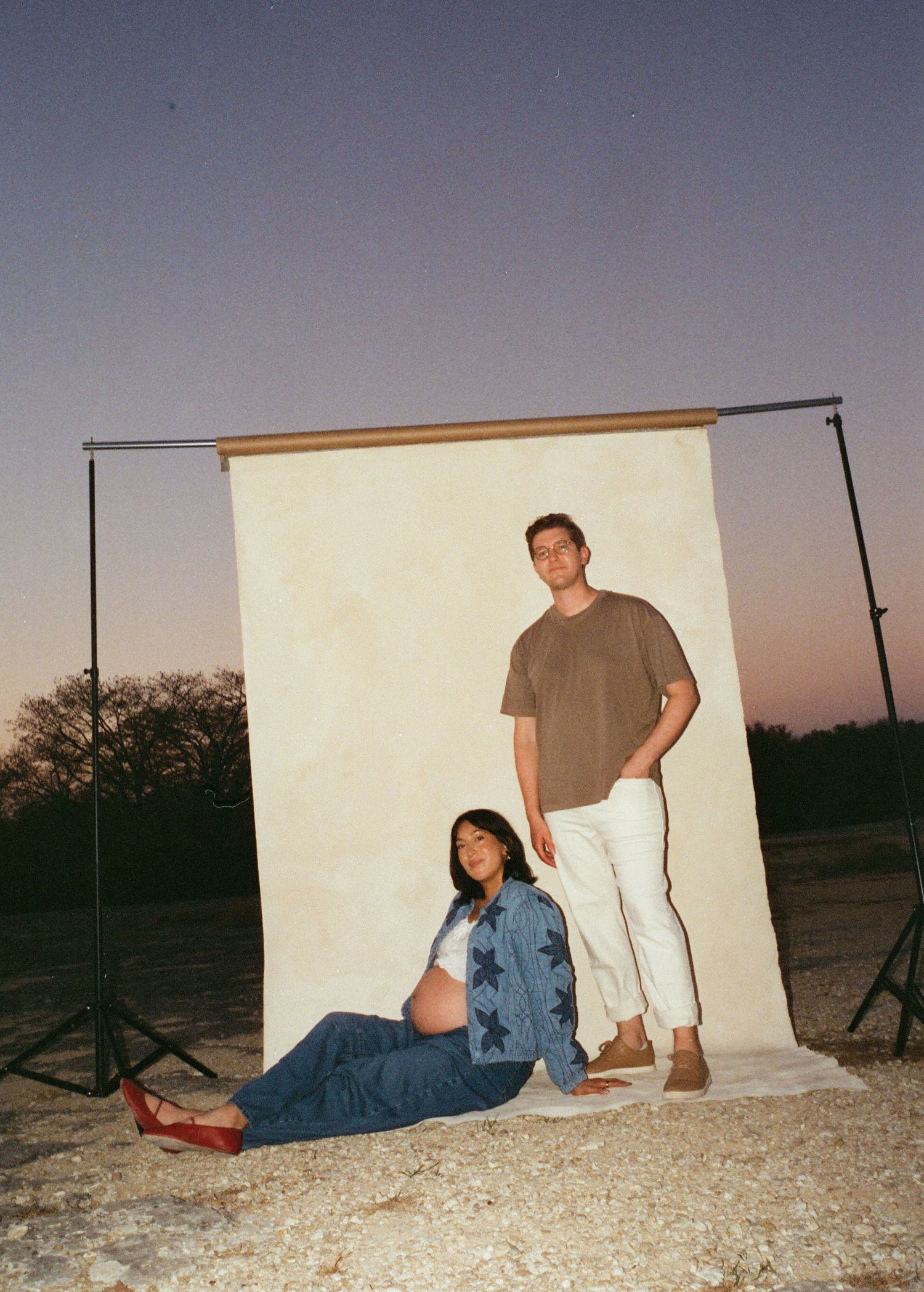 Film maternity portraits in front of a screen backdrop