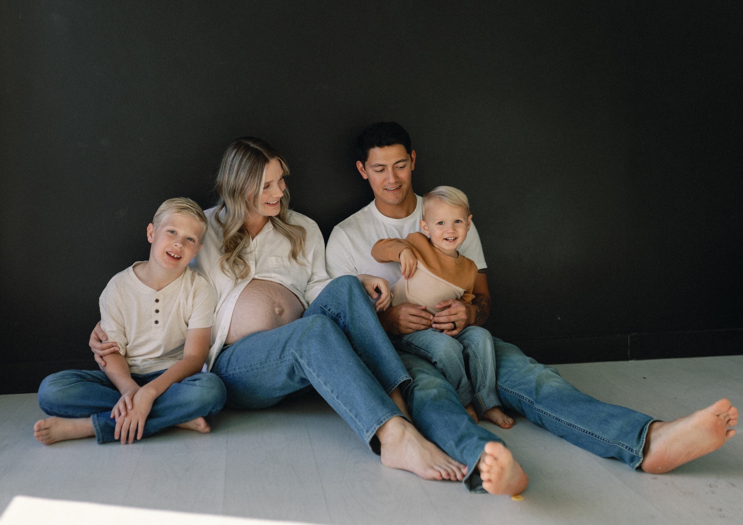 Family joining mama for studio portraits during their maternity and newborn bundle experience