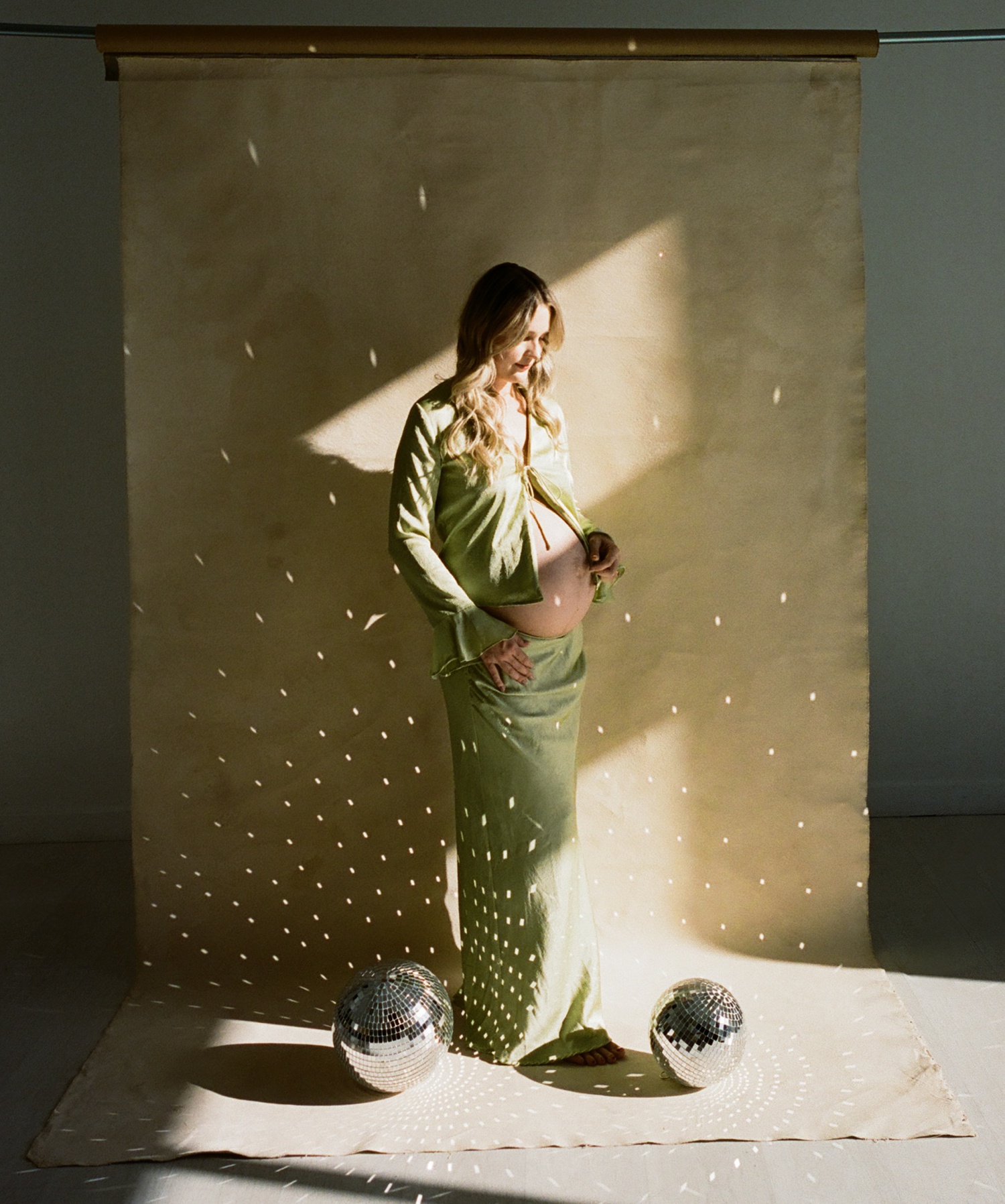 Artistic maternity portraits with disco ball props from an Austin maternity and newborn bundle