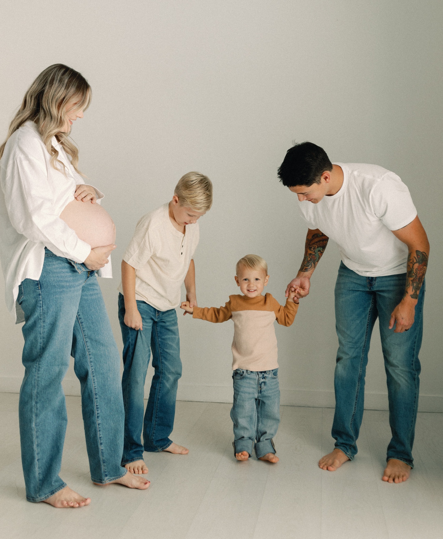 Family joining mama for studio portraits during their maternity and newborn bundle experience