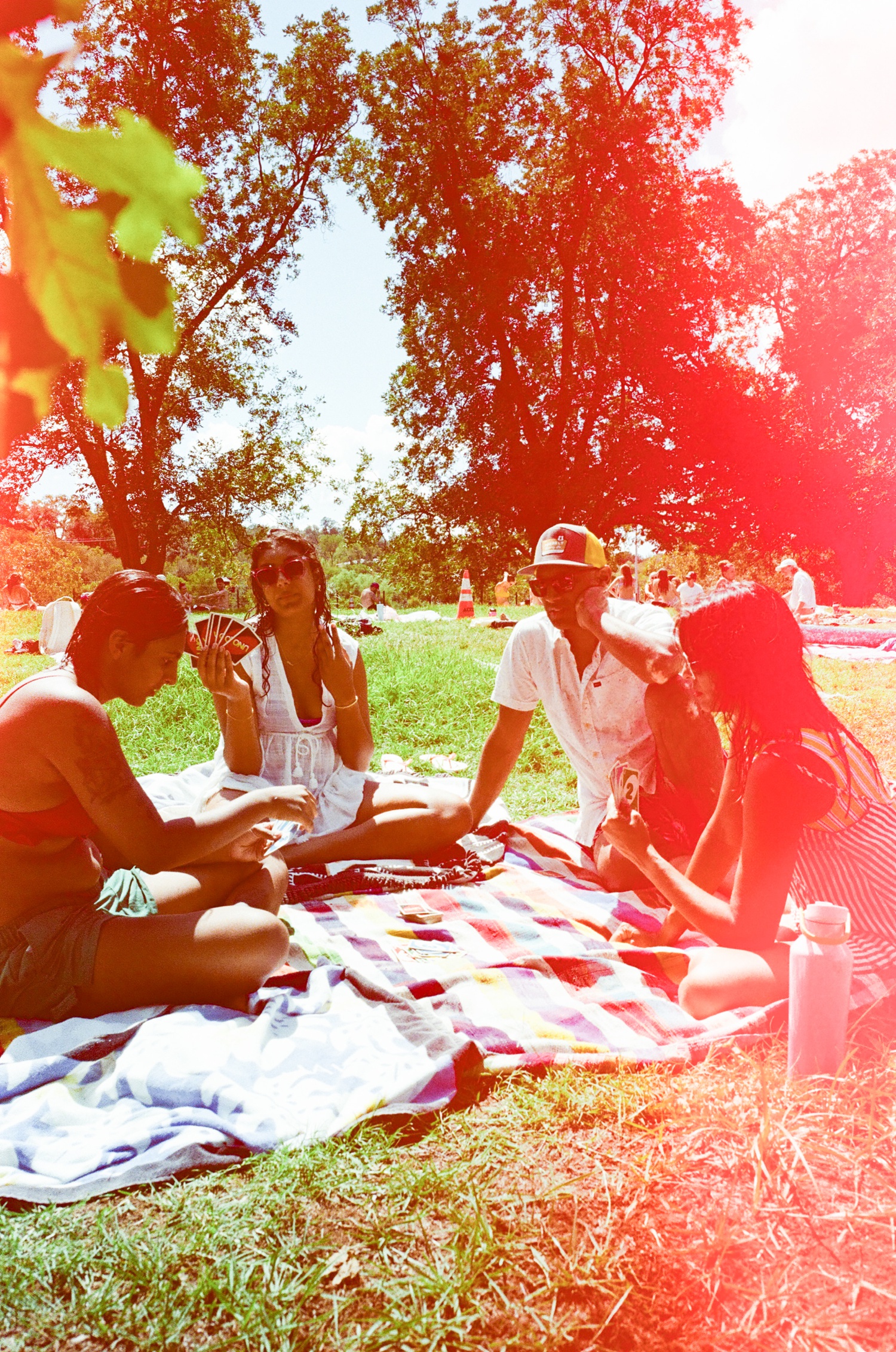 Family playing cards on a beach towel