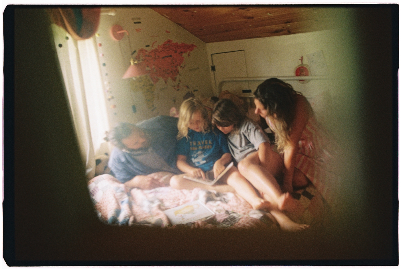 Family reading together on a bed